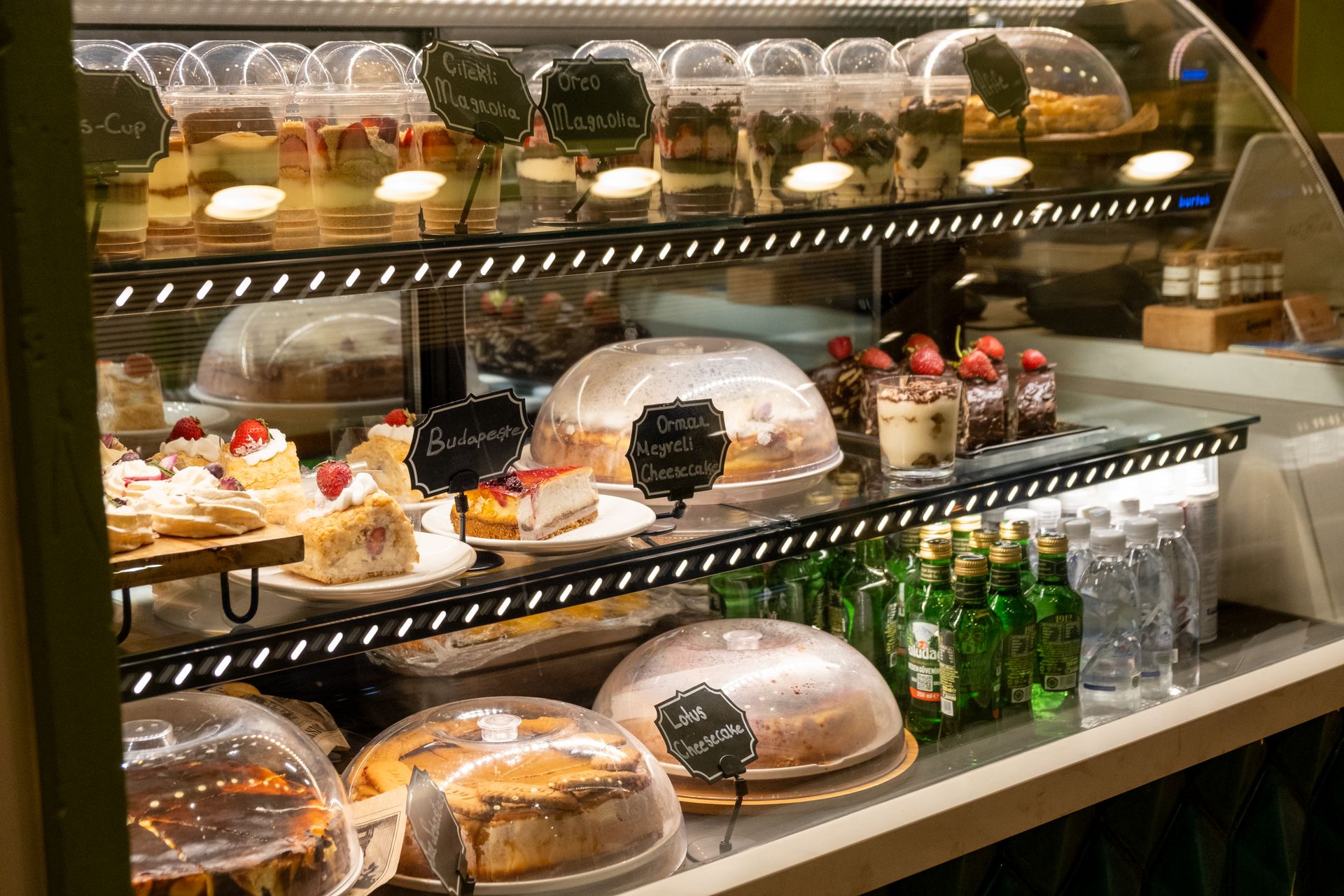 A cafe display case of cakes and pastries